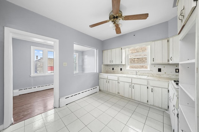 1802 S 50th Ave, Cicero, IL 60804 - kitchen with a baseboard radiator, light countertops, tasteful backsplash, and ceiling fan