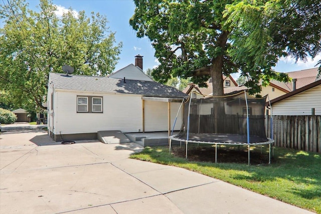 711 W Front St, Bloomington, IL 61701 - rear view of property with a chimney, a trampoline, and a patio