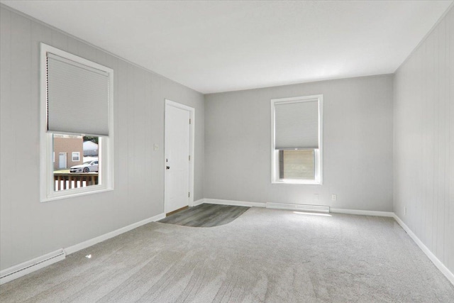 711 W Front St, Bloomington, IL 61701 - empty room with carpet and a baseboard radiator