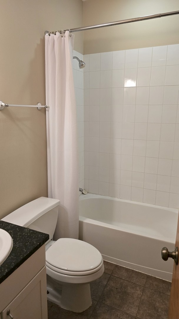 3733 S Lake Park Ave, Chicago, IL 60653 - bathroom with vanity, shower / tub combo with curtain, and tile patterned floors