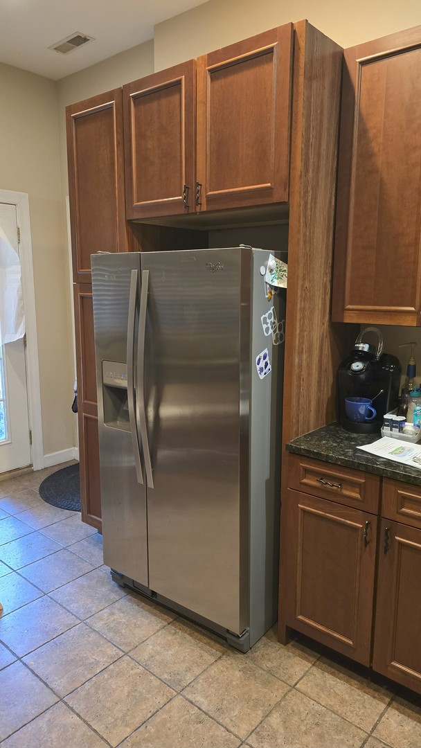 3733 S Lake Park Ave, Chicago, IL 60653 - kitchen featuring stainless steel refrigerator with ice dispenser and dark stone countertops