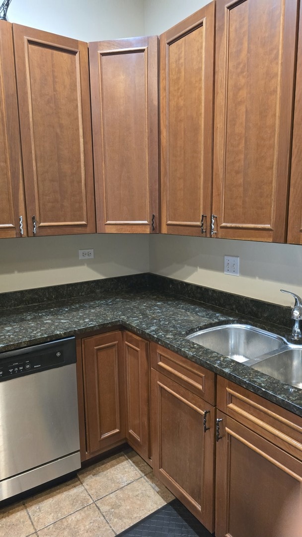 3733 S Lake Park Ave, Chicago, IL 60653 - kitchen with stainless steel dishwasher, light tile patterned floors, and dark stone counters