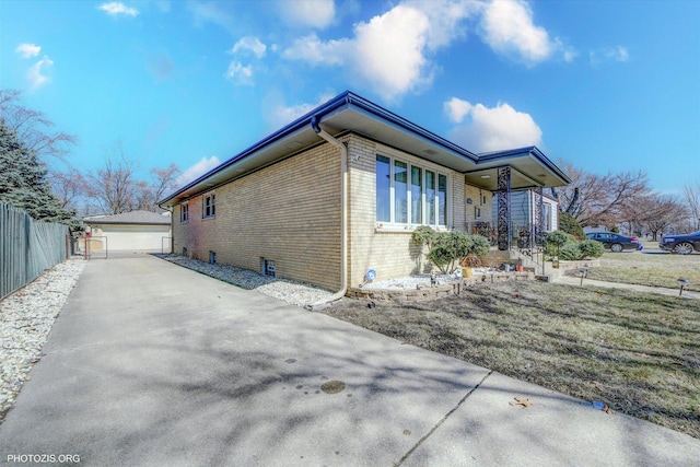 2606 Ridge Rd, Lansing, IL 60438 - view of side of home featuring brick siding, an outdoor structure, a porch, and a garage