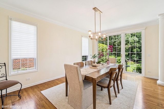 823 Balmoral Ln, Northbrook, IL 60062 - dining area featuring crown molding, a chandelier, light wood-type flooring, and ornate columns