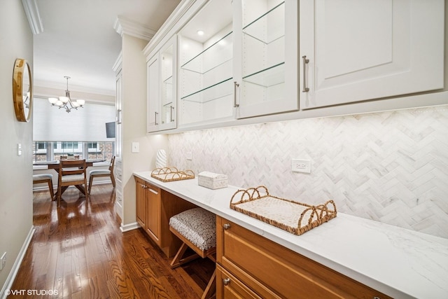 823 Balmoral Ln, Northbrook, IL 60062 - kitchen with crown molding, decorative backsplash, dark wood-style floors, white cabinetry, and a chandelier