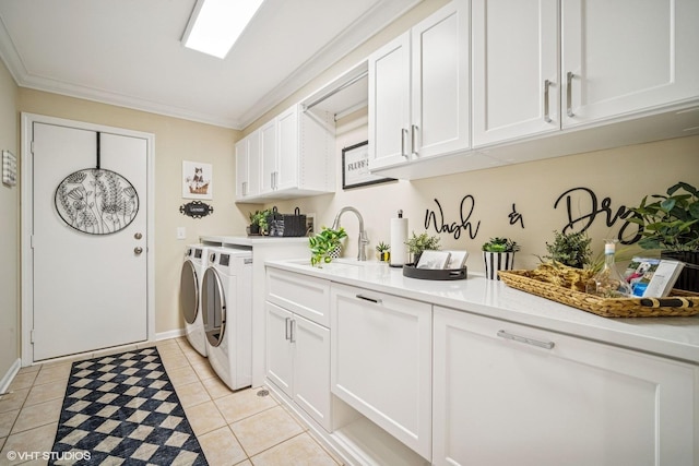 823 Balmoral Ln, Northbrook, IL 60062 - laundry area featuring washing machine and dryer, cabinet space, light tile patterned floors, and ornamental molding
