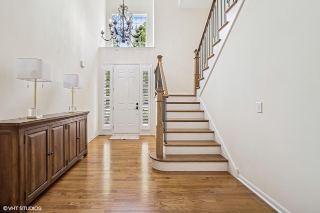 823 Balmoral Ln, Northbrook, IL 60062 - entryway featuring light wood-type flooring, a chandelier, a high ceiling, and stairway