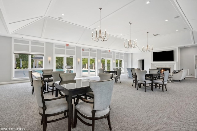 823 Balmoral Ln, Northbrook, IL 60062 - carpeted dining space featuring a chandelier, a warm lit fireplace, and recessed lighting