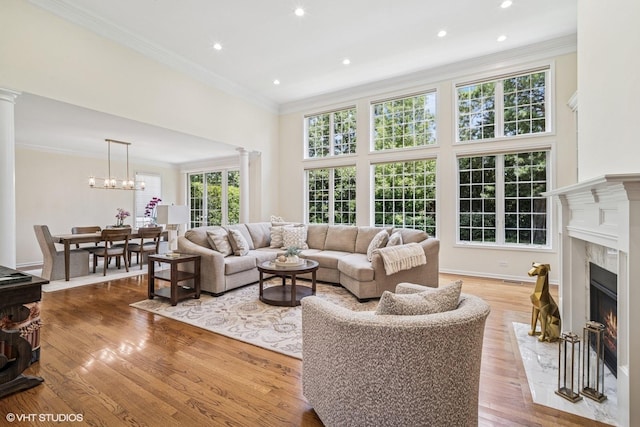 823 Balmoral Ln, Northbrook, IL 60062 - living room with a fireplace, ornamental molding, light wood finished floors, recessed lighting, and a chandelier