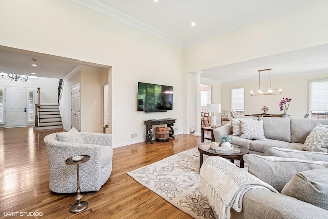 823 Balmoral Ln, Northbrook, IL 60062 - living room with a chandelier, wood finished floors, ornamental molding, stairway, and recessed lighting
