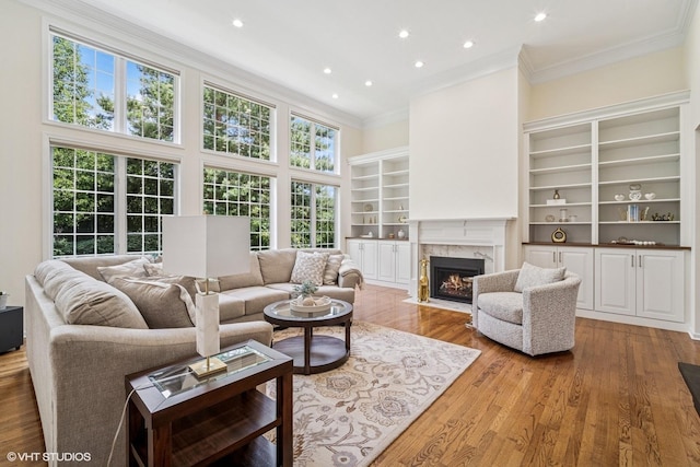 823 Balmoral Ln, Northbrook, IL 60062 - living room with a high end fireplace, crown molding, recessed lighting, wood finished floors, and a high ceiling