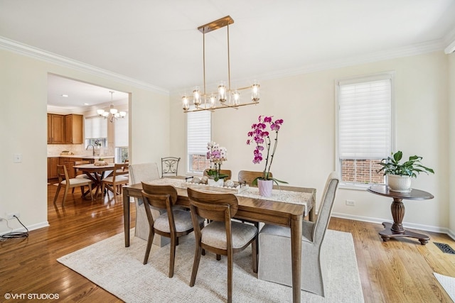 823 Balmoral Ln, Northbrook, IL 60062 - dining space with a chandelier, crown molding, and light wood-type flooring