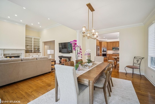 823 Balmoral Ln, Northbrook, IL 60062 - dining space featuring ornamental molding, recessed lighting, a high end fireplace, wood finished floors, and healthy amount of natural light