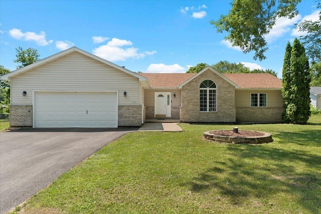 10067 W Logan Ct, Zion, IL 60099 - ranch-style home featuring brick siding, asphalt driveway, a garage, a front lawn, and roof with shingles