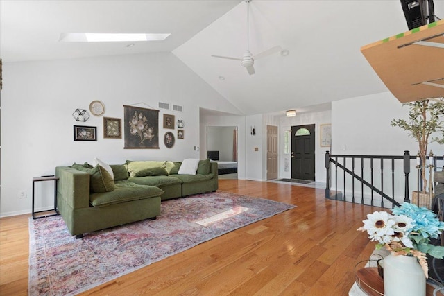 10067 W Logan Ct, Zion, IL 60099 - living room featuring high vaulted ceiling, a skylight, wood finished floors, and ceiling fan