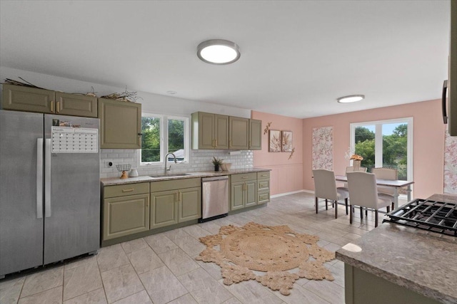 10067 W Logan Ct, Zion, IL 60099 - kitchen with freestanding refrigerator, dishwasher, healthy amount of natural light, and backsplash