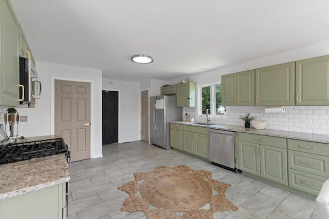 10067 W Logan Ct, Zion, IL 60099 - kitchen featuring green cabinets, appliances with stainless steel finishes, tasteful backsplash, and light stone counters