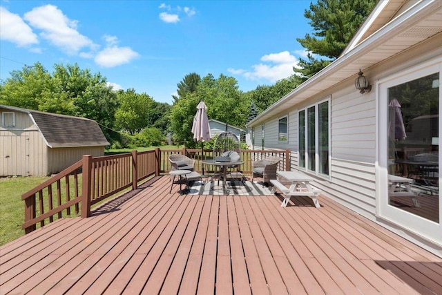 10067 W Logan Ct, Zion, IL 60099 - wooden terrace with a storage shed and outdoor dining area