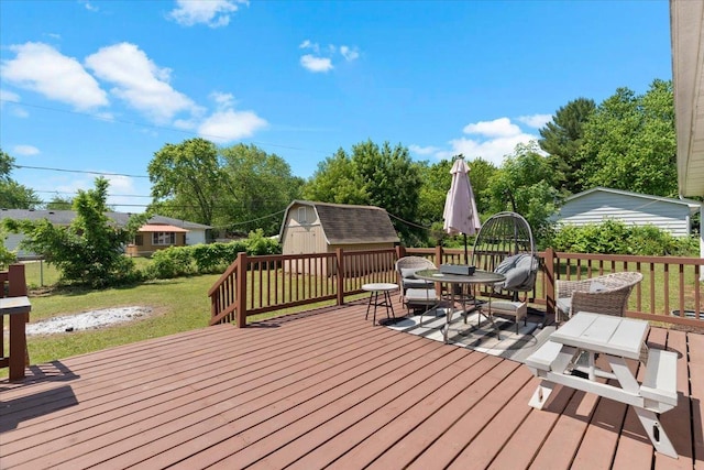 10067 W Logan Ct, Zion, IL 60099 - wooden deck featuring a storage shed, a lawn, and outdoor dining space