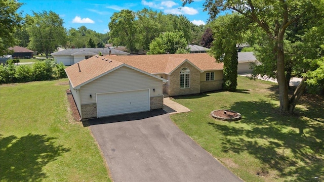 10067 W Logan Ct, Zion, IL 60099 - ranch-style home featuring brick siding, asphalt driveway, a garage, and a front lawn