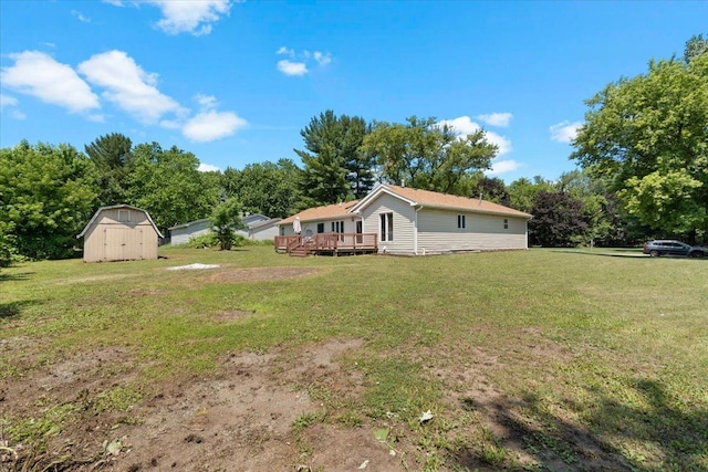 10067 W Logan Ct, Zion, IL 60099 - view of grassy yard with a storage unit, a wooden deck, and view of scattered trees