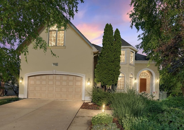 1123 Chadwick Ct, Aurora, IL 60502 - view of front facade featuring stucco siding, concrete driveway, and a garage