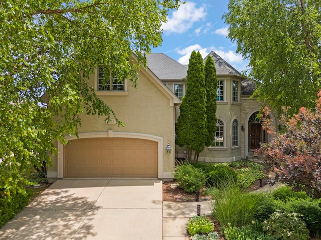 1123 Chadwick Ct, Aurora, IL 60502 - view of front facade with stucco siding, driveway, and a garage