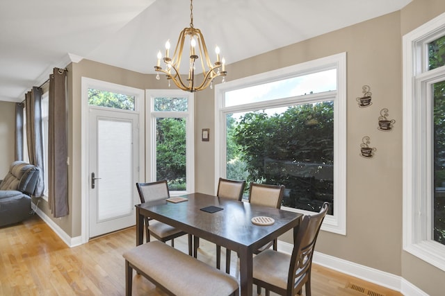 1123 Chadwick Ct, Aurora, IL 60502 - dining area with a chandelier, healthy amount of natural light, and light wood-type flooring