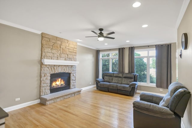 1123 Chadwick Ct, Aurora, IL 60502 - living area with crown molding, a stone fireplace, wood finished floors, ceiling fan, and recessed lighting