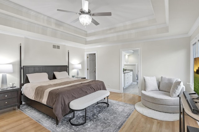 1123 Chadwick Ct, Aurora, IL 60502 - bedroom with a raised ceiling, light wood-style floors, ornamental molding, connected bathroom, and a ceiling fan