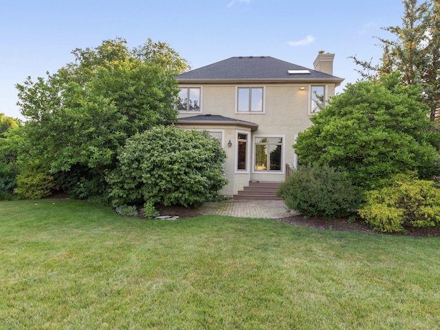1123 Chadwick Ct, Aurora, IL 60502 - view of front of property with a chimney, stucco siding, a front lawn, and entry steps