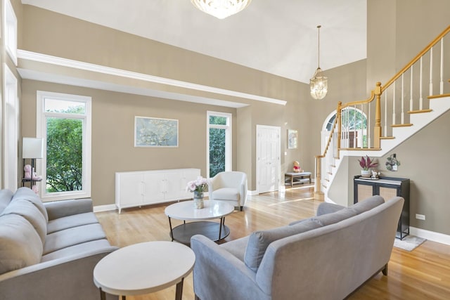 1123 Chadwick Ct, Aurora, IL 60502 - living area with stairway, wood finished floors, a high ceiling, and a chandelier