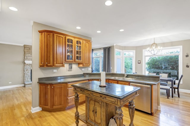 1123 Chadwick Ct, Aurora, IL 60502 - kitchen with dishwasher, dark countertops, a peninsula, brown cabinets, and a chandelier