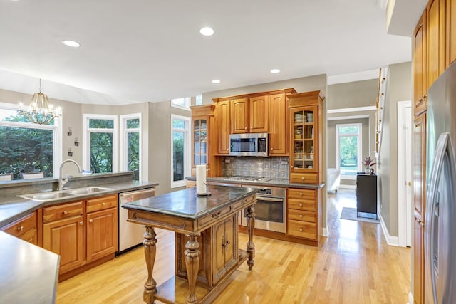 1123 Chadwick Ct, Aurora, IL 60502 - kitchen featuring stainless steel appliances, brown cabinetry, light wood-type flooring, a chandelier, and recessed lighting