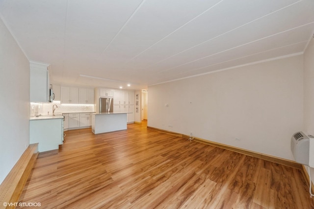 18 E Old Willow Rd Unit 106N, Prospect Heights, IL 60070 - unfurnished living room with light wood-type flooring and baseboards