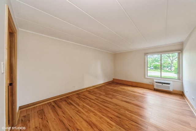 18 E Old Willow Rd Unit 106N, Prospect Heights, IL 60070 - spare room featuring an AC wall unit and light wood-style floors