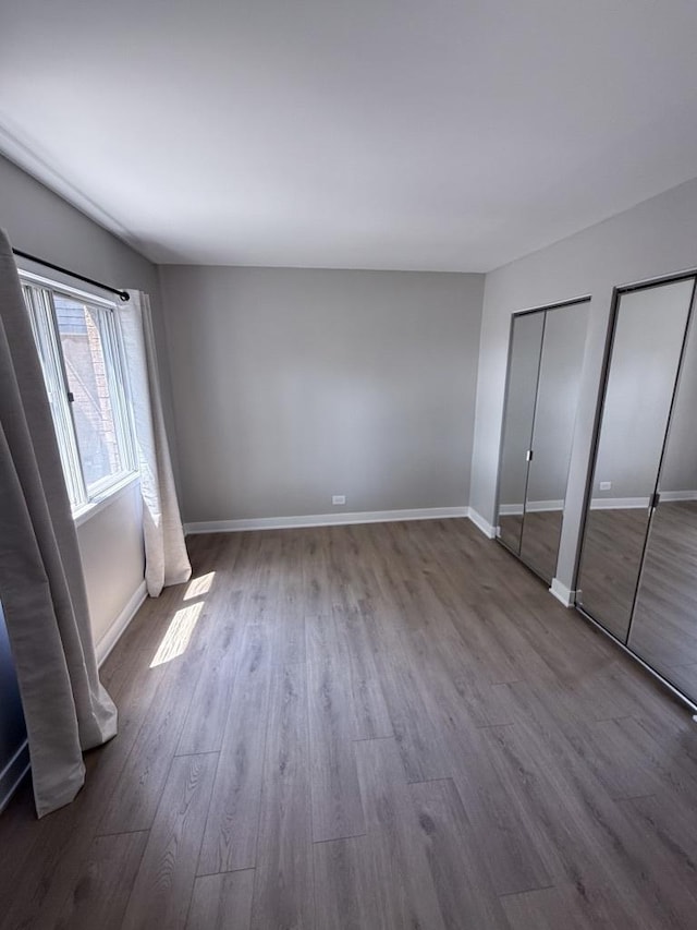 4819 W 109th St Unit 204, Oak Lawn, IL 60453 - unfurnished bedroom with wood finished floors and multiple closets