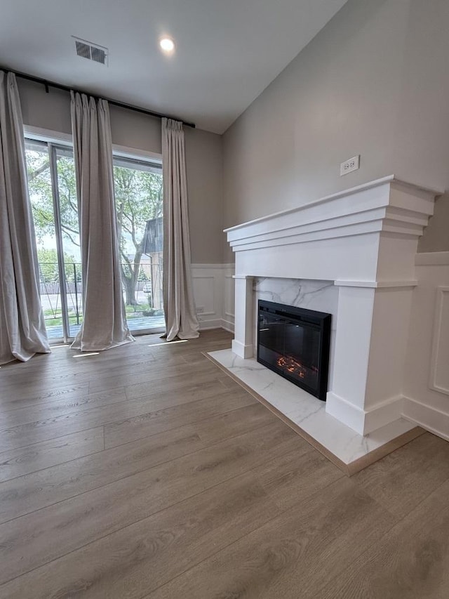 4819 W 109th St Unit 204, Oak Lawn, IL 60453 - unfurnished living room featuring a fireplace, a decorative wall, wood finished floors, wainscoting, and recessed lighting