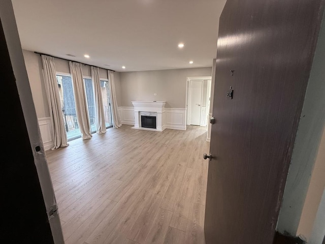 4819 W 109th St Unit 204, Oak Lawn, IL 60453 - unfurnished living room featuring a decorative wall, light wood-style floors, recessed lighting, a wainscoted wall, and a high end fireplace