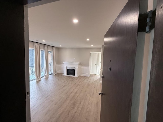 4819 W 109th St Unit 204, Oak Lawn, IL 60453 - unfurnished living room featuring recessed lighting, a fireplace, a decorative wall, light wood-type flooring, and wainscoting