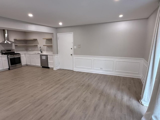 4819 W 109th St Unit 204, Oak Lawn, IL 60453 - kitchen featuring appliances with stainless steel finishes, wall chimney range hood, open shelves, light countertops, and a wainscoted wall