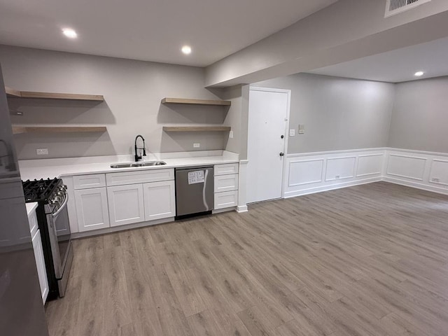 4819 W 109th St Unit 204, Oak Lawn, IL 60453 - kitchen featuring open shelves, stainless steel appliances, light wood-style flooring, light countertops, and a wainscoted wall