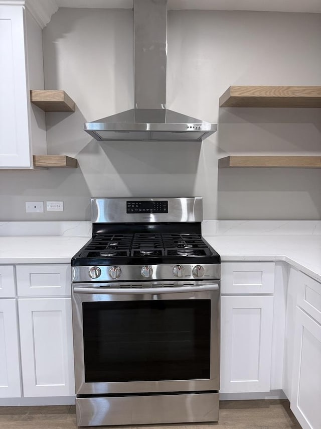4819 W 109th St Unit 204, Oak Lawn, IL 60453 - kitchen with open shelves, gas stove, wall chimney range hood, light wood finished floors, and white cabinets