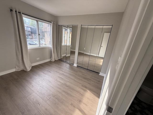 4819 W 109th St Unit 204, Oak Lawn, IL 60453 - unfurnished bedroom featuring wood finished floors and multiple closets