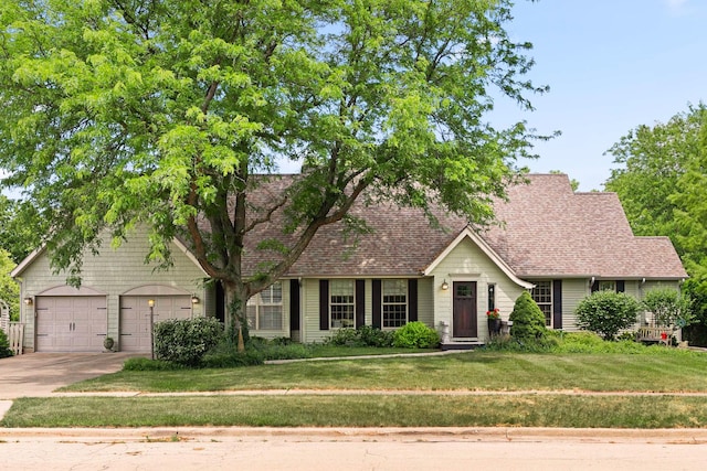 3063 Wedgewood Dr, Dekalb, IL 60115 - view of front of home with concrete driveway, a front lawn, an attached garage, and a shingled roof