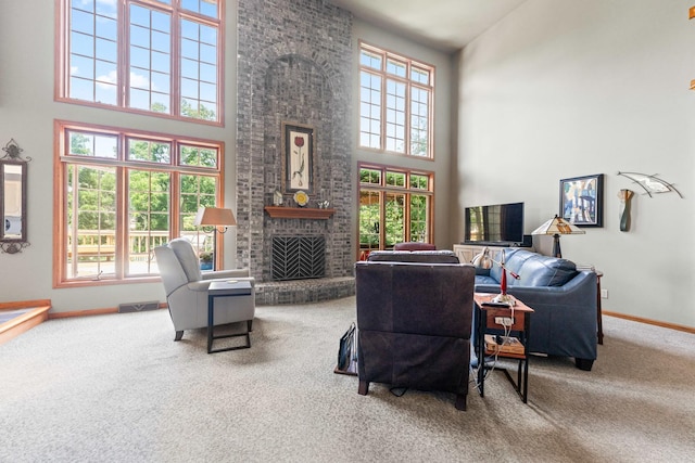 3063 Wedgewood Dr, Dekalb, IL 60115 - carpeted living area featuring a high ceiling, a brick fireplace, and healthy amount of natural light