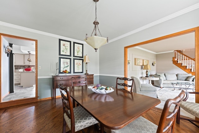 3063 Wedgewood Dr, Dekalb, IL 60115 - dining room featuring wood finished floors, stairs, and ornamental molding