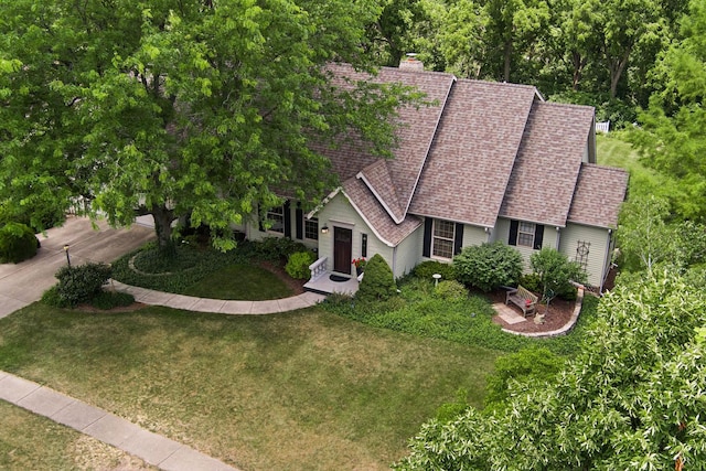 3063 Wedgewood Dr, Dekalb, IL 60115 - view of front of house with roof with shingles, a front yard, and a chimney