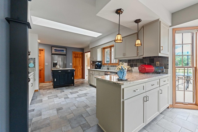 3063 Wedgewood Dr, Dekalb, IL 60115 - kitchen with stainless steel appliances, a peninsula, healthy amount of natural light, and backsplash