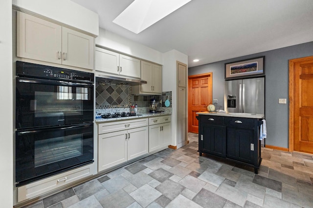 3063 Wedgewood Dr, Dekalb, IL 60115 - kitchen with black appliances, a skylight, stone finish flooring, tasteful backsplash, and under cabinet range hood